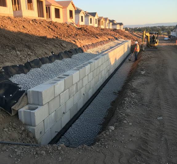 How to Know If You Need a Retaining Wall or a Slope Drainage Fix